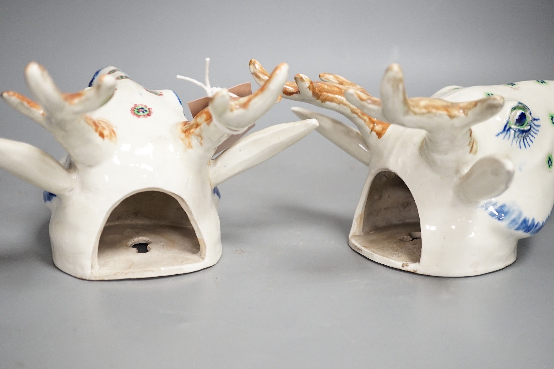 Two Continental pottery stag head wall pockets, 22cms high